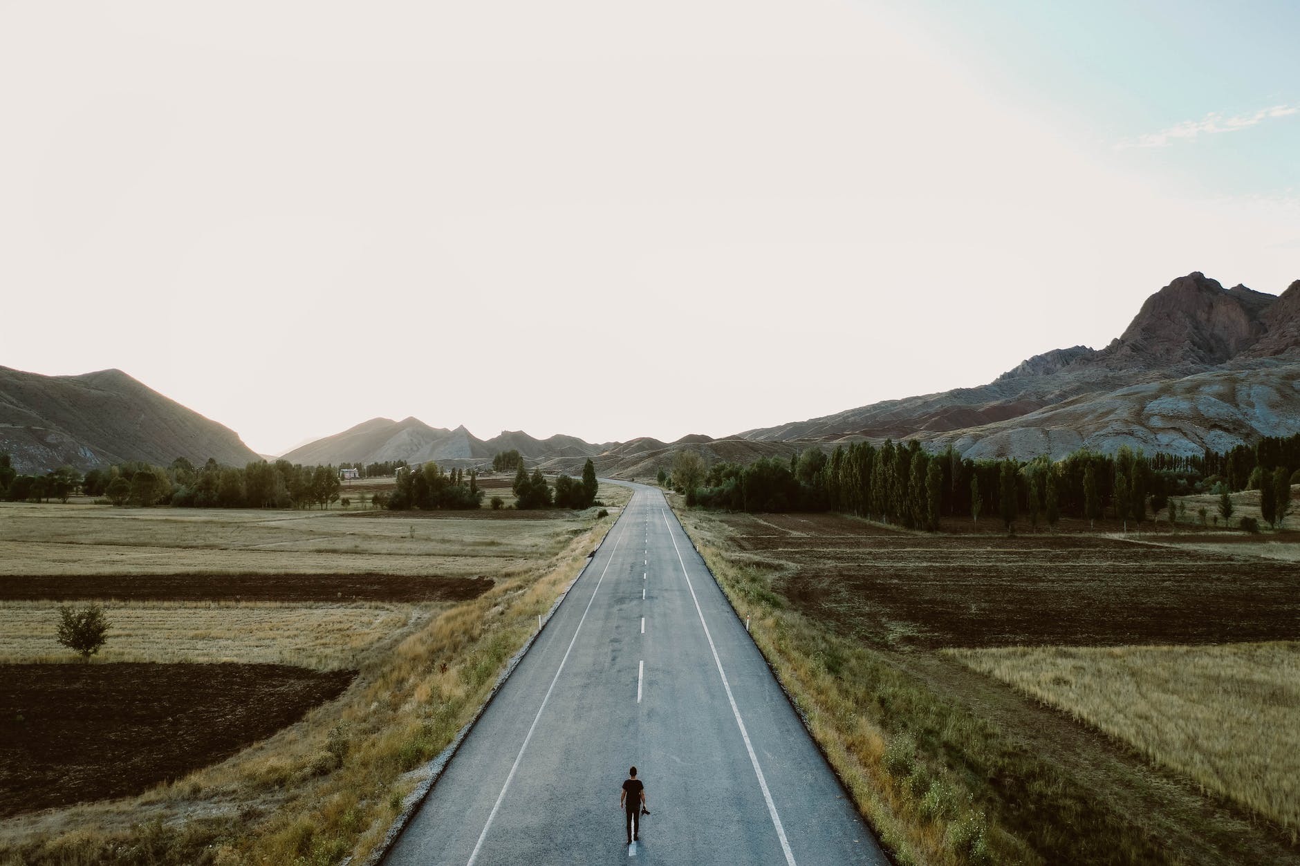 a person standing alone on country road